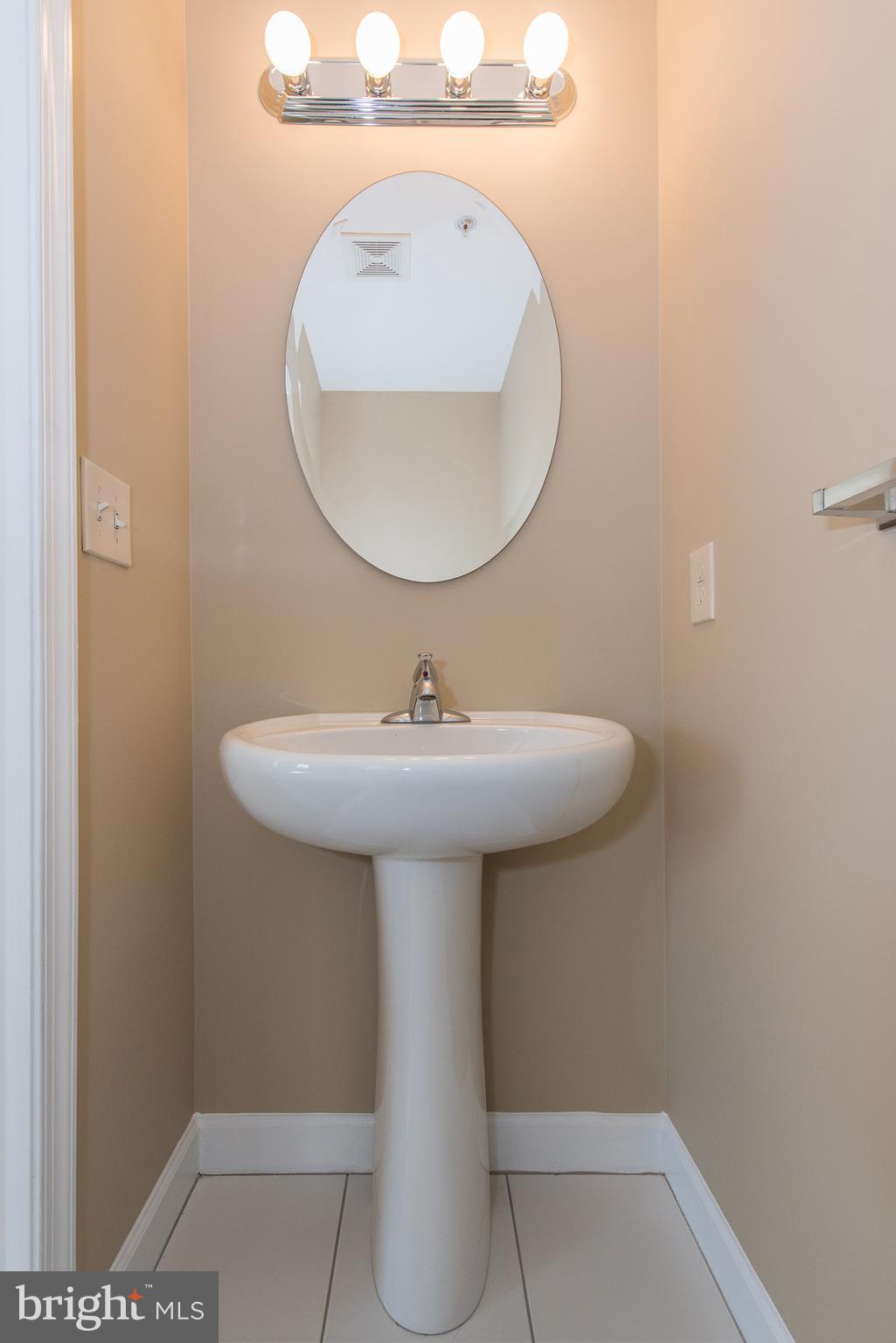 1005 Wampler Road Baltimore, MD 21220 - Photo 15 of 30 a bathroom with a sink a mirror and a lamp