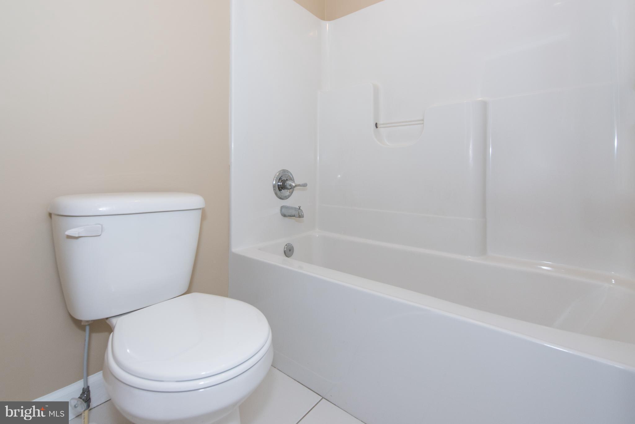 1005 Wampler Road Baltimore, MD 21220 - Photo 19 of 30 a white toilet sitting next to a bath tub