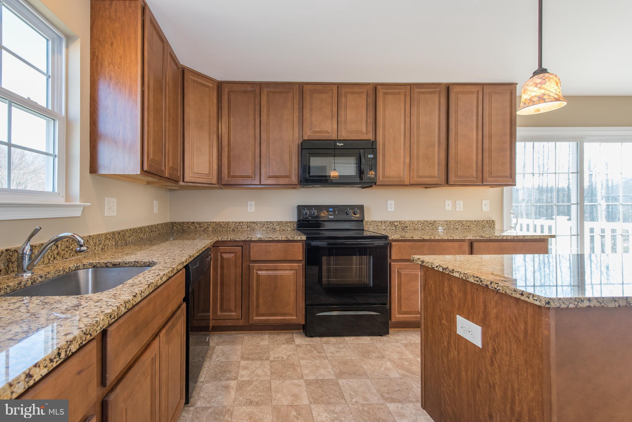 1005 Wampler Road Baltimore, MD 21220 - Photo 10 of 30 a kitchen with stainless steel appliances granite countertop a sink stove and cabinets