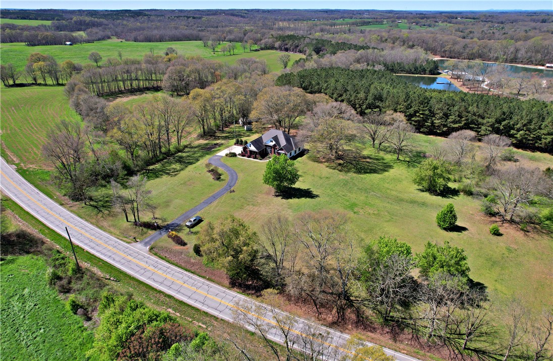 7893 Athens Road Carnesville, GA 30521 - Photo 50 of 50 This expansive estate boasts a private drive, scenic lake, and abundant greenery.