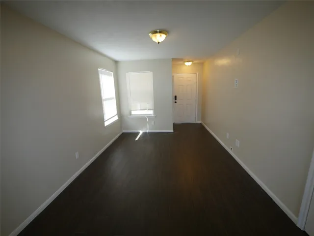 an empty room with windows and closet