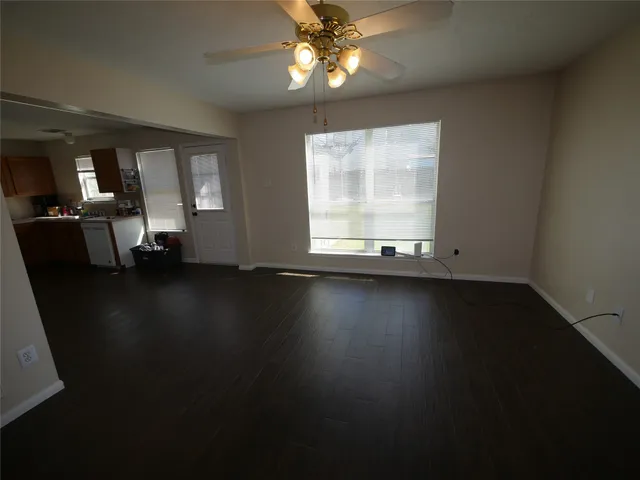 a view of a livingroom with furniture wooden floor and a window