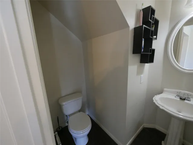 a white toilet sitting next to a sink