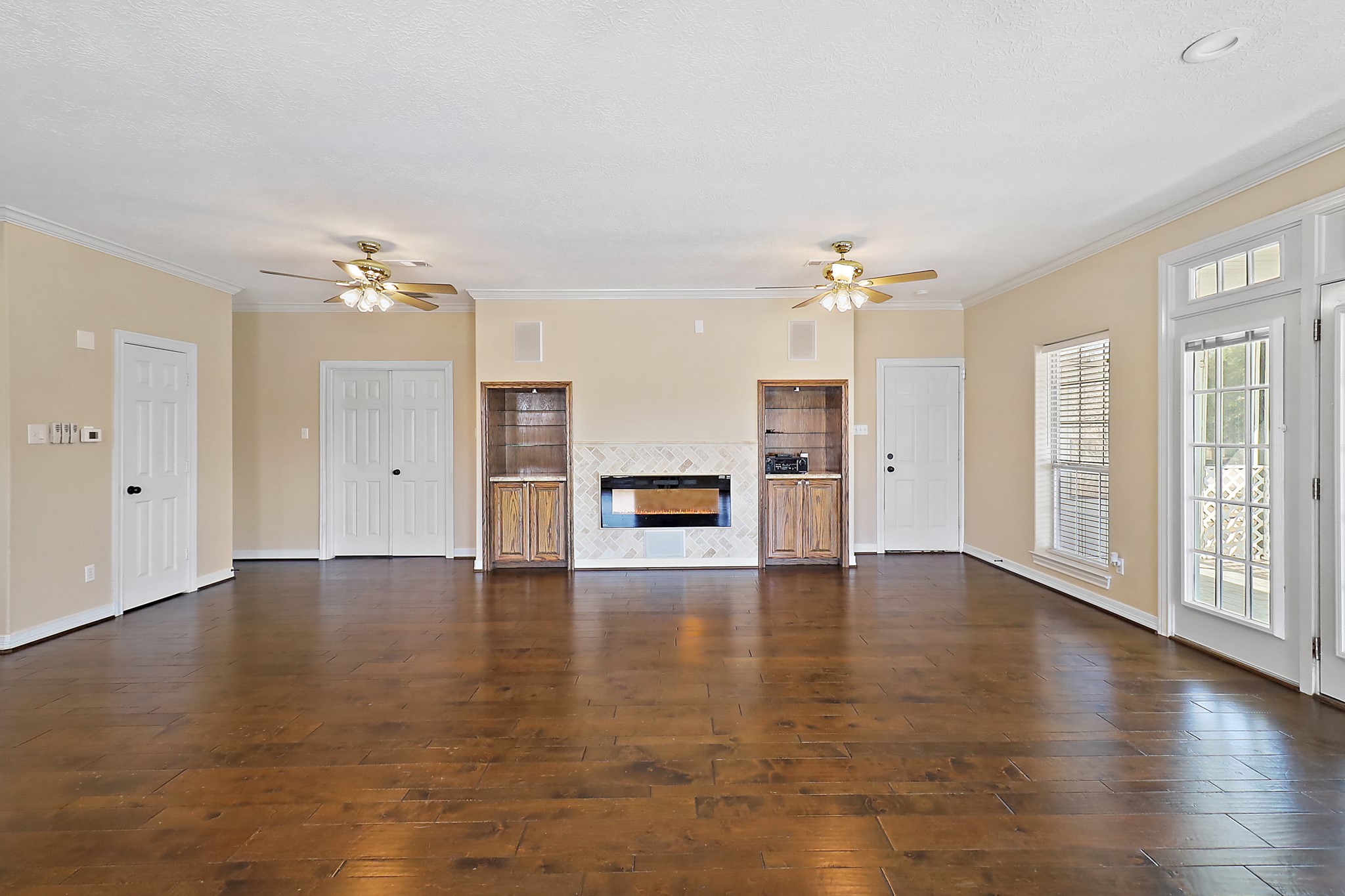 1306 Spring Branch Drive Baytown, TX 77523 - Photo 32 of 38 a view of an empty room with a window and wooden floor