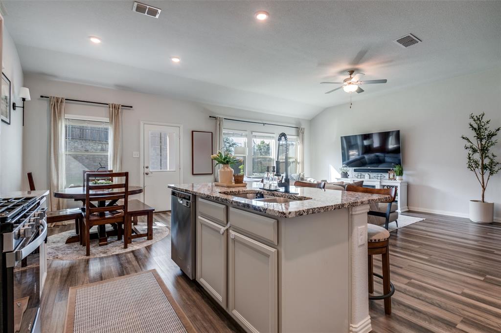 2419 Lalun Lane Forney, TX 75126 - Photo 12 of 25 a kitchen with sink cabinets and dining table