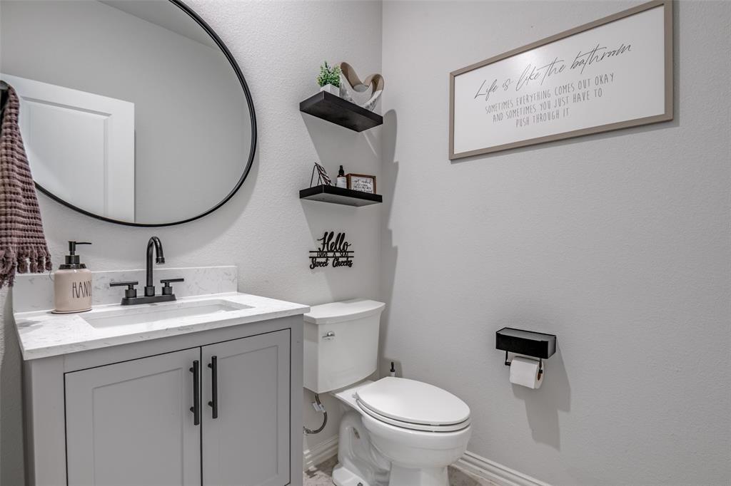 2419 Lalun Lane Forney, TX 75126 - Photo 18 of 25 a bathroom with a toilet sink and mirror
