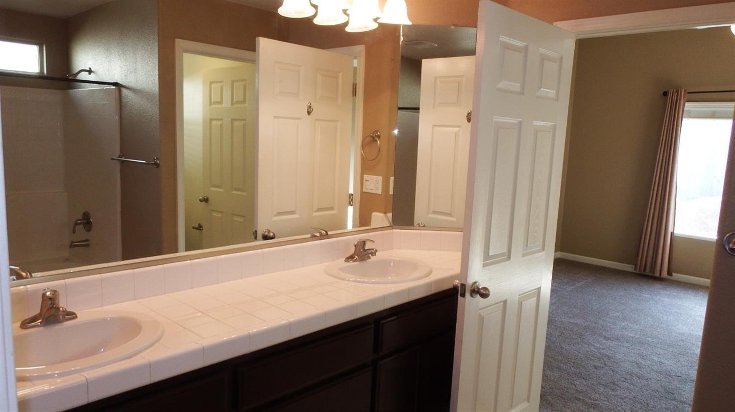 941 Marc Avenue Fowler, CA 93625 - Photo 7 of 11 a bathroom with a sink and a mirror