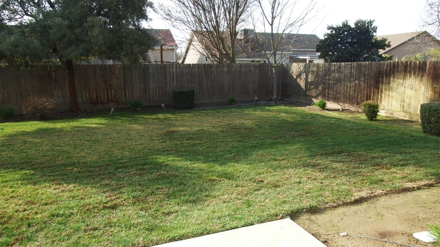 941 Marc Avenue Fowler, CA 93625 - Photo 9 of 11 a backyard of a house with lots of green space