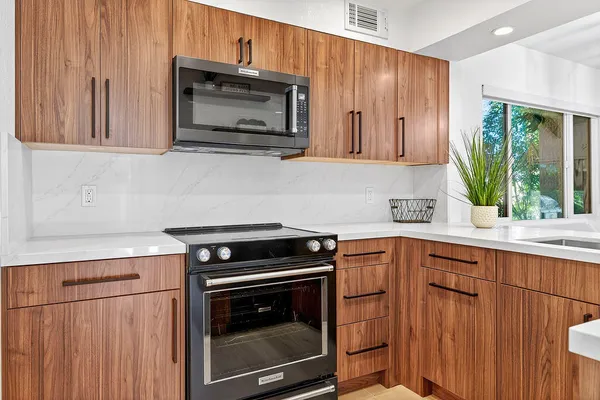 a kitchen that has a sink and a large window