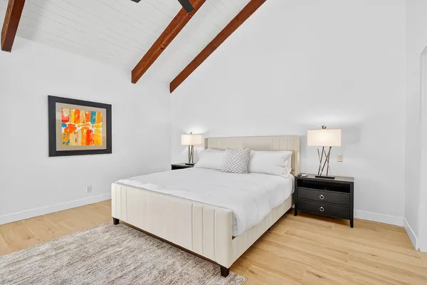 a bedroom with a bed and a night stand