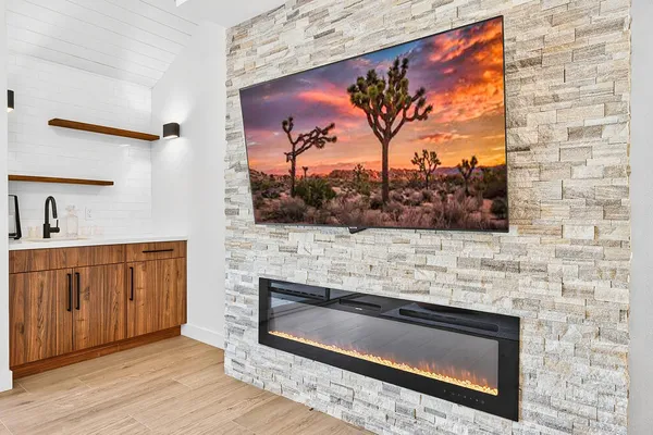 a view of living room with a flat screen tv and a fireplace