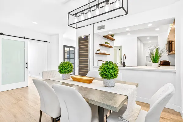 a dining room with furniture and potted plant