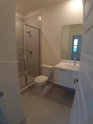 a view of gallery with lots of frames on wall and window