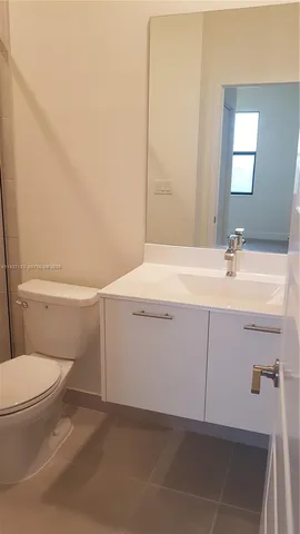a bathroom with a sink a toilet and mirror