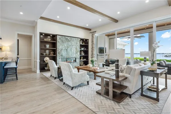 a living room with furniture dining table and a large window