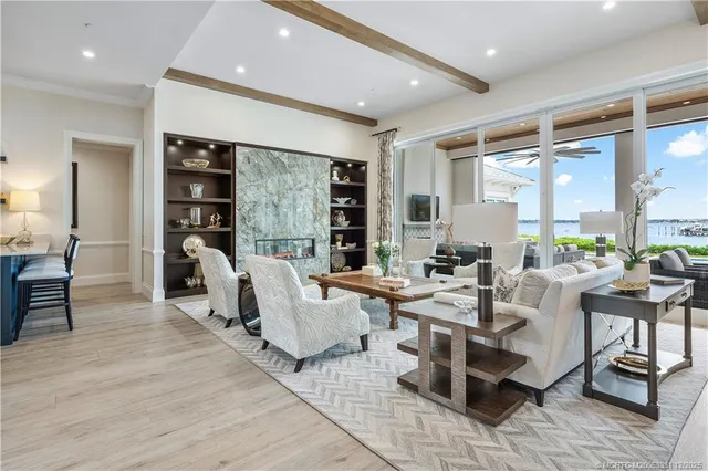 a living room with furniture dining table and a large window