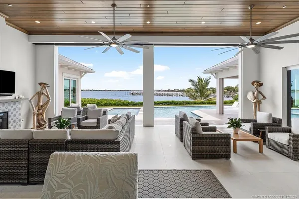 a living room with large window and a flat screen tv