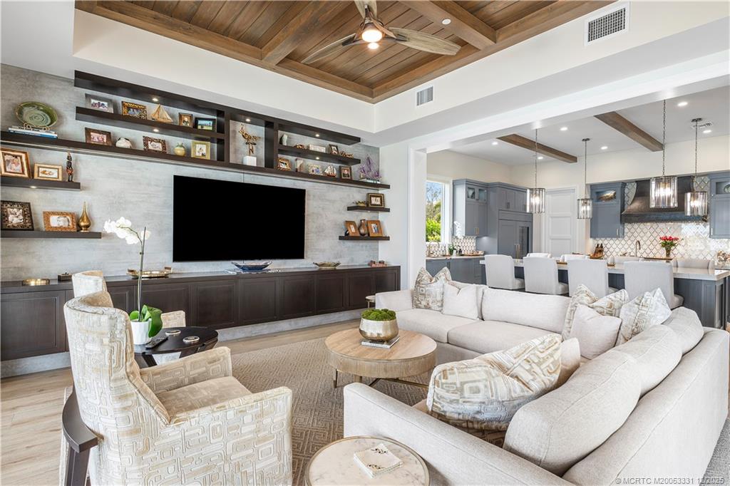2842 Southwest Rivers End Way Palm City, FL 34990 - Photo 27 of 99 a living room with furniture and a flat screen tv