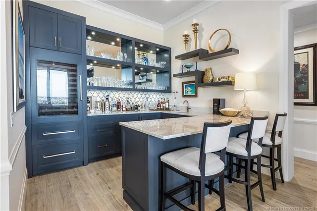 a living room with furniture a dining table and a chandelier