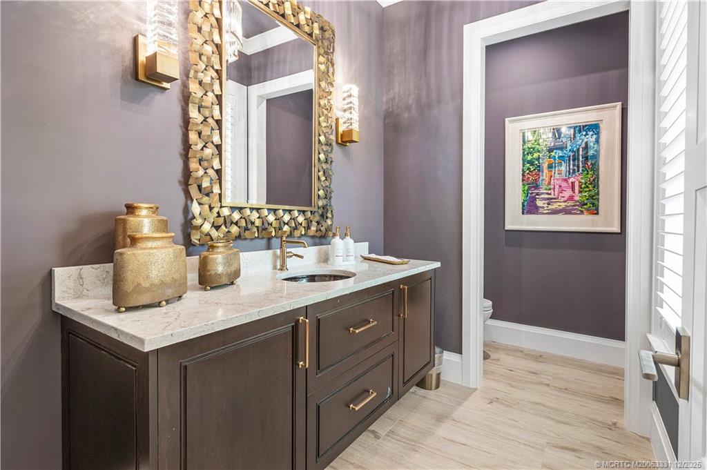 2842 Southwest Rivers End Way Palm City, FL 34990 - Photo 31 of 99 a bathroom with a sink vanity and a mirror