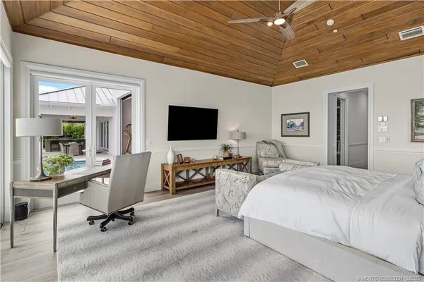 a spacious bedroom with two beds and a window