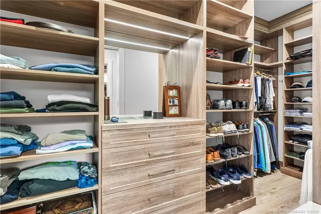a view of outdoor kitchen with dining table and chairs