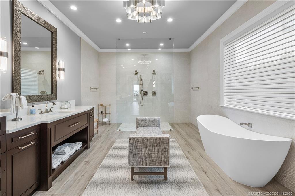 2842 Southwest Rivers End Way Palm City, FL 34990 - Photo 37 of 99 a spacious bathroom with a double vanity sink large mirror and bathtub