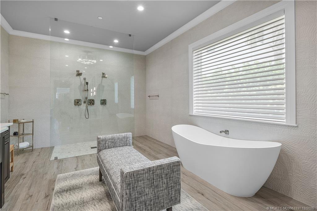 2842 Southwest Rivers End Way Palm City, FL 34990 - Photo 40 of 99 a bathroom with a bathtub and shower