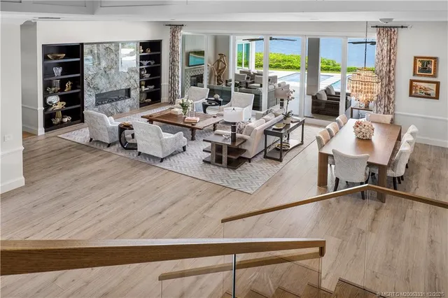a living room with furniture a flat screen tv and a floor to ceiling window