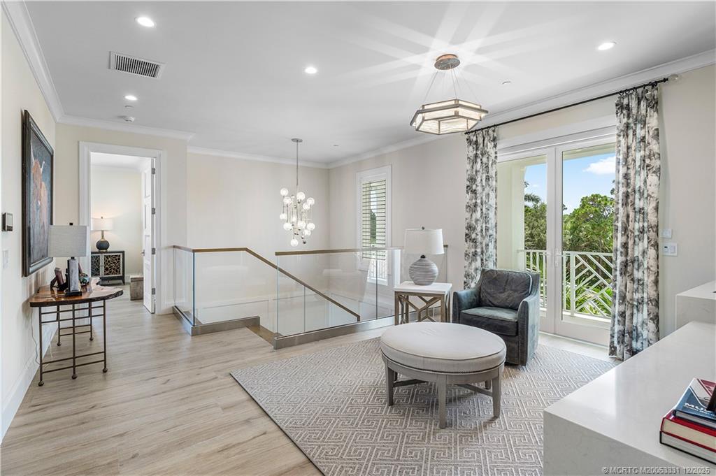2842 Southwest Rivers End Way Palm City, FL 34990 - Photo 46 of 99 a living room with furniture a dining table and a chandelier