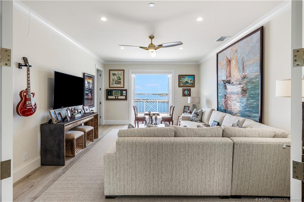 2842 Southwest Rivers End Way Palm City, FL 34990 - Photo 48 of 99 a living room with furniture and a flat screen tv