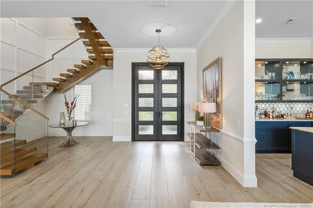a view of a hallway with wooden floor and staircase