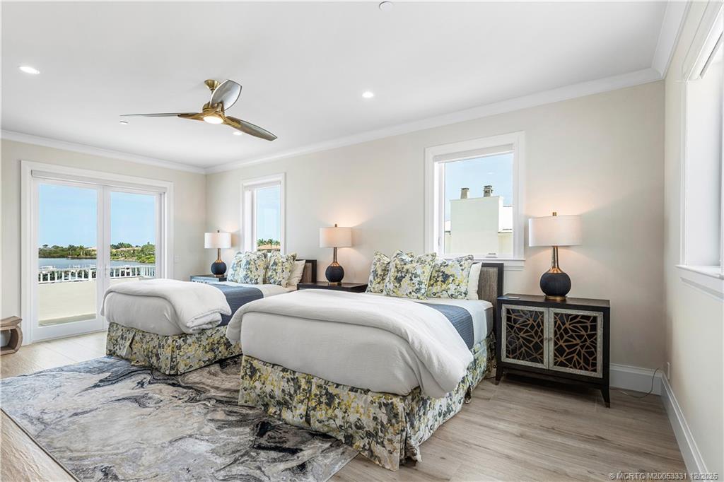 2842 Southwest Rivers End Way Palm City, FL 34990 - Photo 59 of 99 a spacious bedroom with two beds and a window