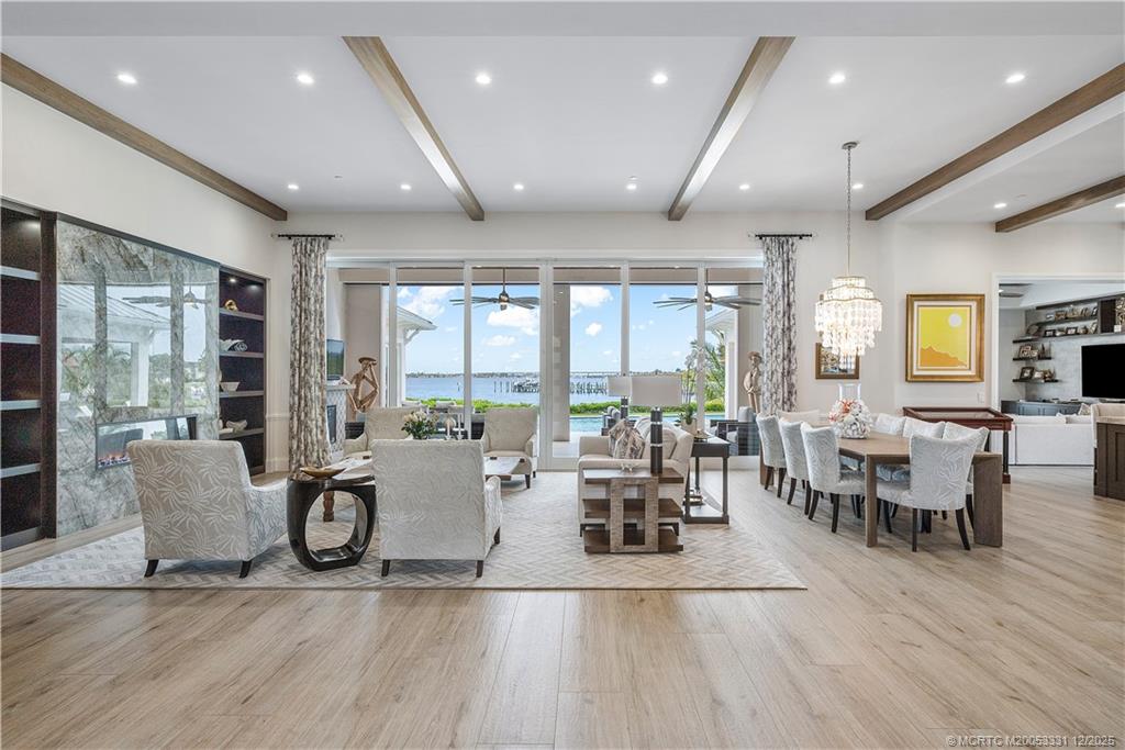 2842 Southwest Rivers End Way Palm City, FL 34990 - Photo 6 of 99 a living room with furniture wooden floor and a floor to ceiling window