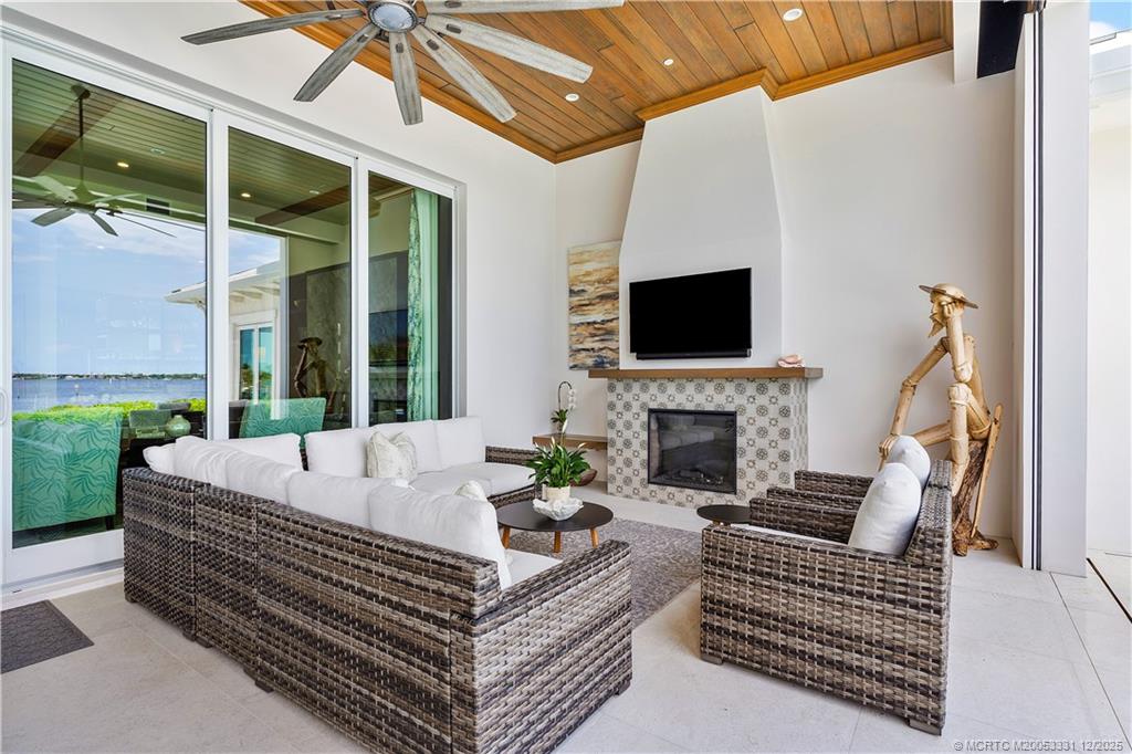 2842 Southwest Rivers End Way Palm City, FL 34990 - Photo 63 of 99 a outdoor space with patio the couches and a fireplace