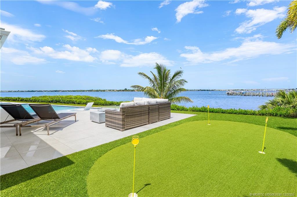 2842 Southwest Rivers End Way Palm City, FL 34990 - Photo 72 of 99 a view of a swimming pool with an outdoor seating and a garden