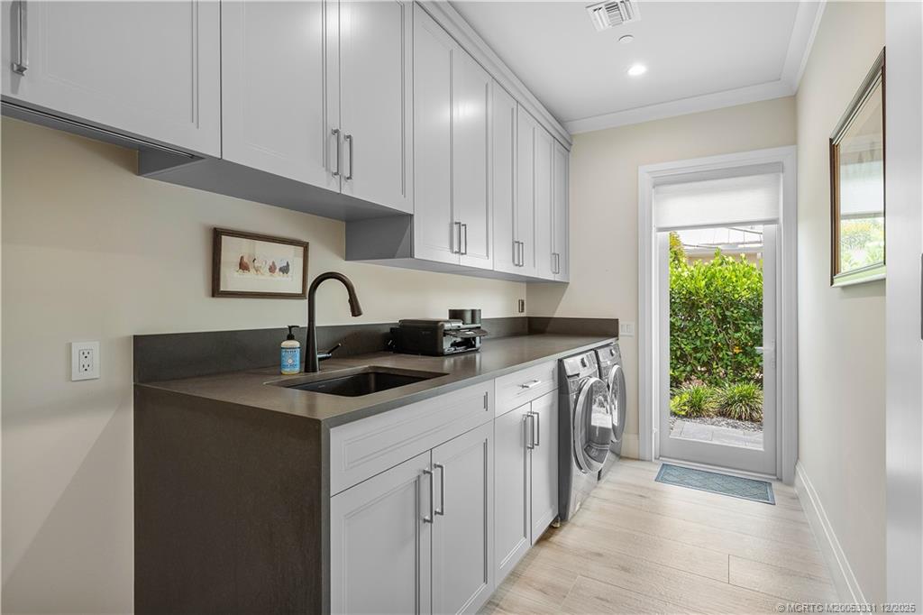 2842 Southwest Rivers End Way Palm City, FL 34990 - Photo 80 of 99 a kitchen with a sink stove and cabinets