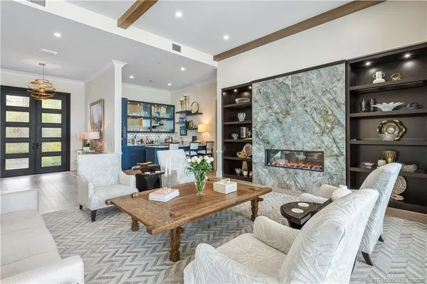 a living room with lots of furniture and a large window