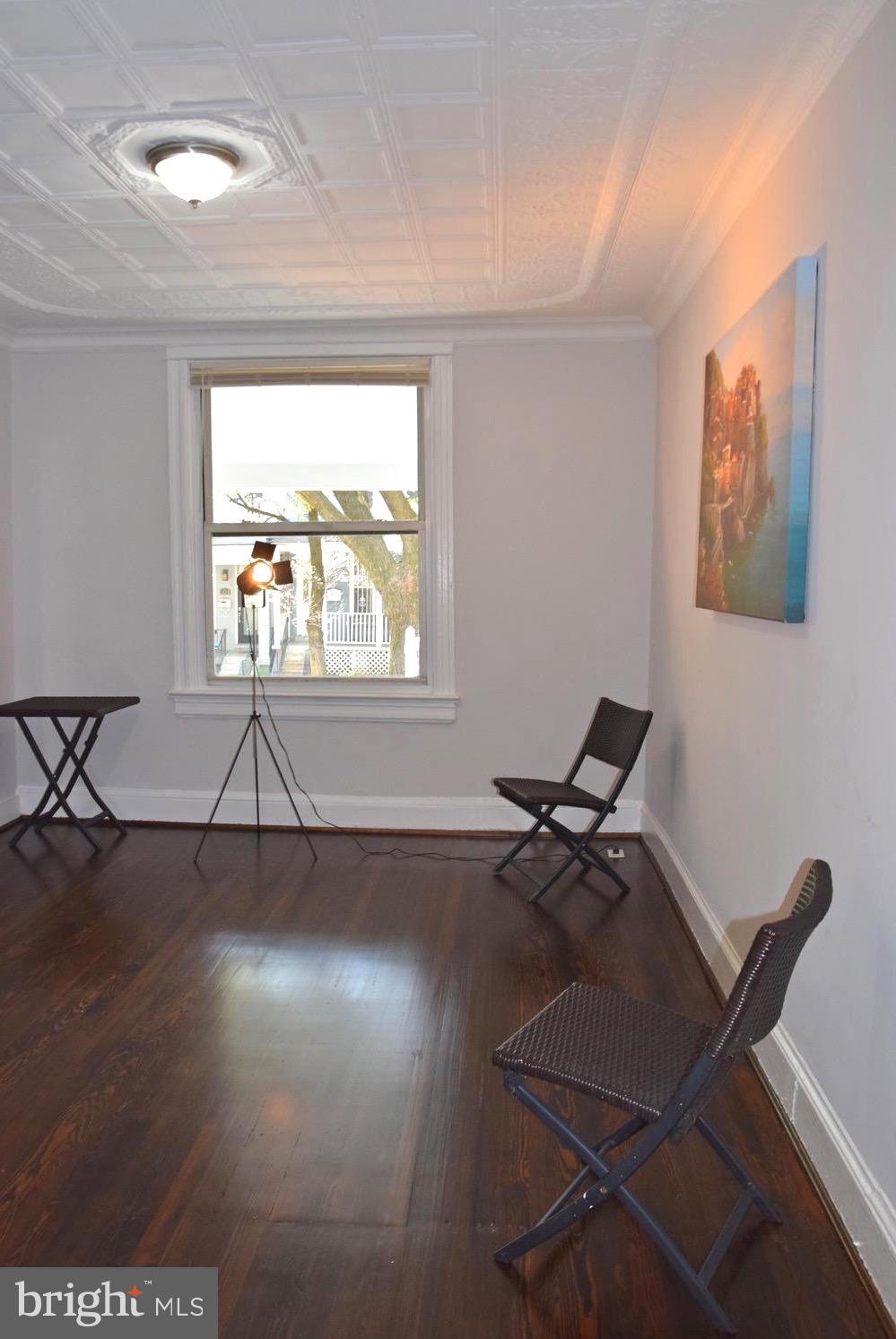 607 Columbia Road Northwest Washington, DC 20001 - Photo 12 of 48 Living room with elegant pressed tin ceiling