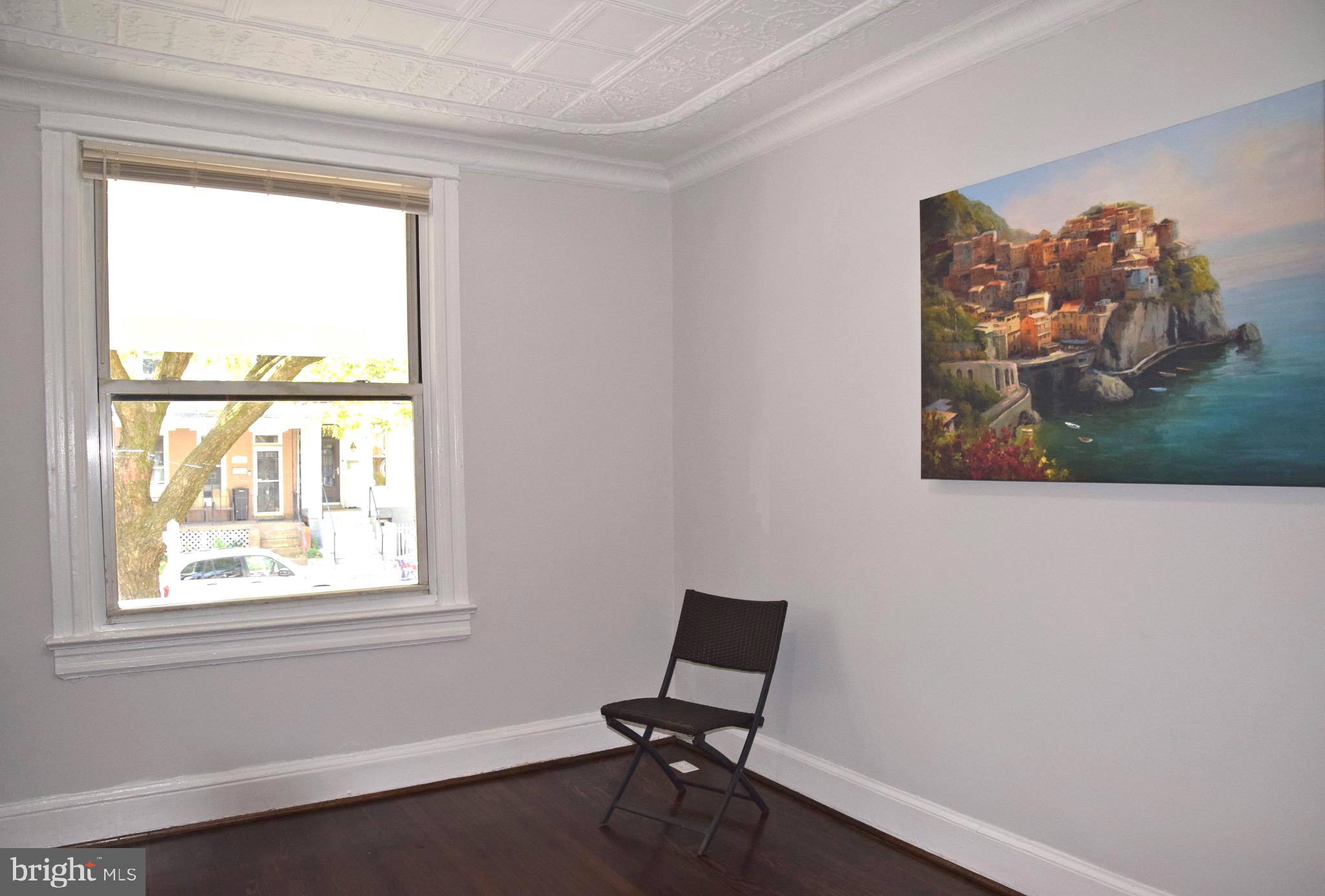 607 Columbia Road Northwest Washington, DC 20001 - Photo 10 of 48 Living room with elegant pressed tin ceiling