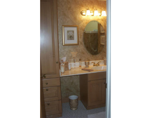 130 Mountain Gate Road, Unit 130 Ashland, MA 01721 - Photo 11 of 12 a bathroom with a sink and mirror