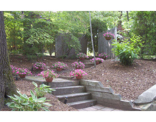 130 Mountain Gate Road, Unit 130 Ashland, MA 01721 - Photo 2 of 12 a backyard of a house with yard and outdoor seating
