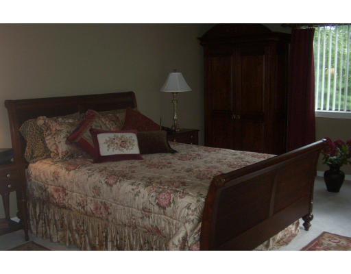 130 Mountain Gate Road, Unit 130 Ashland, MA 01721 - Photo 8 of 12 a bed sitting in a bedroom next to a window