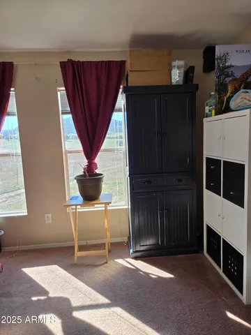 a living room with a couch a rug and a window