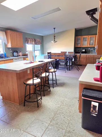 a living room with stainless steel appliances kitchen island granite countertop furniture and a kitchen view