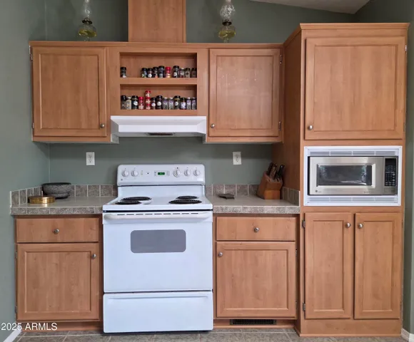 a kitchen with granite countertop cabinets stainless steel appliances and a sink