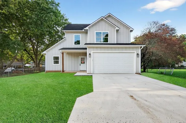 a front view of house with yard and green space