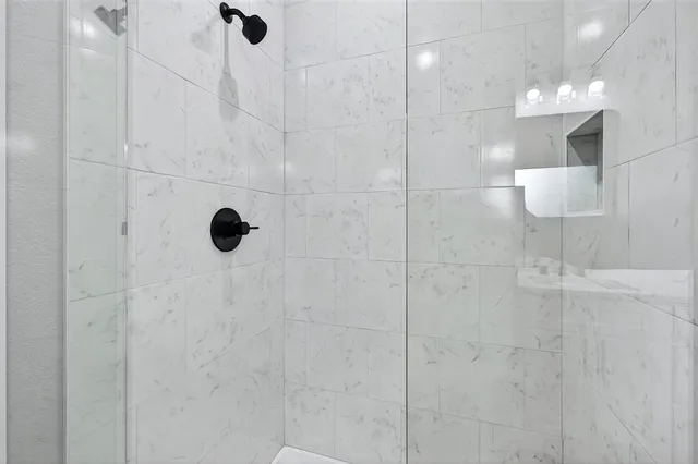 a bathroom with a tub and shower