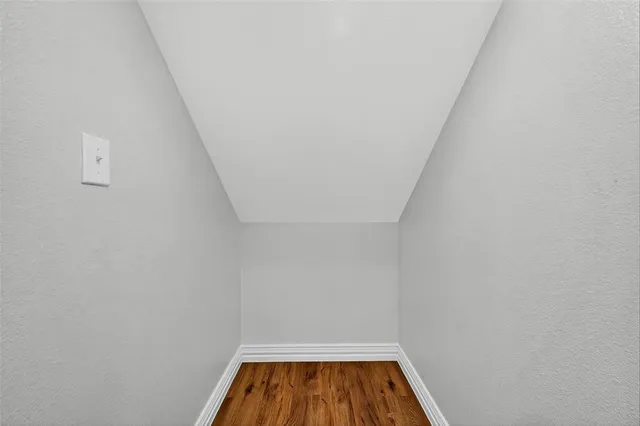 a spacious bathroom with a glass shower door and a sink
