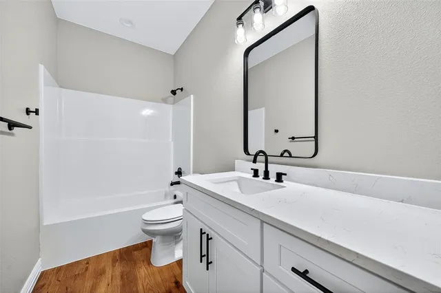 an empty room with a ceiling fan and carpet